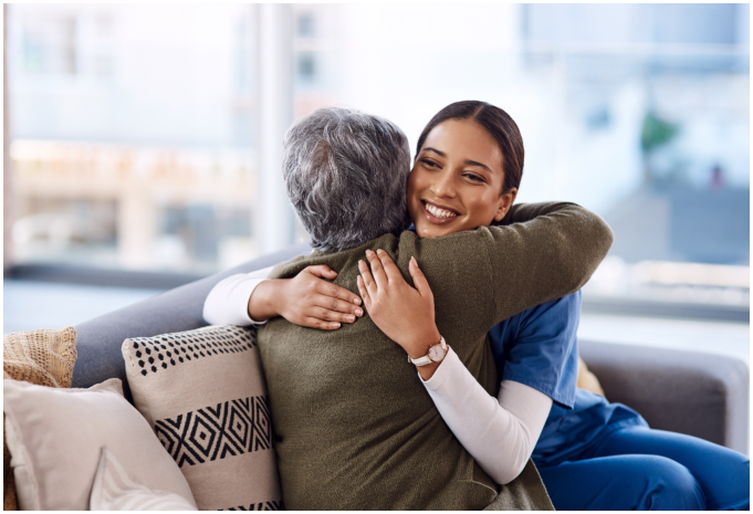 Caregiver hugging the elderly